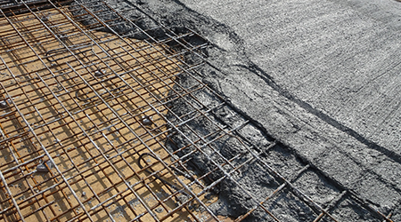 The wet concrete poured on a steel reinforcement bar to form strong floor slabs called reinforce concrete floor slab.                                 