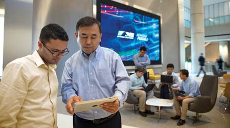 Two men looking at a tablet